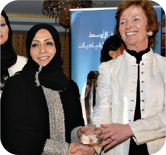 Women leaders exchanging a crystal award